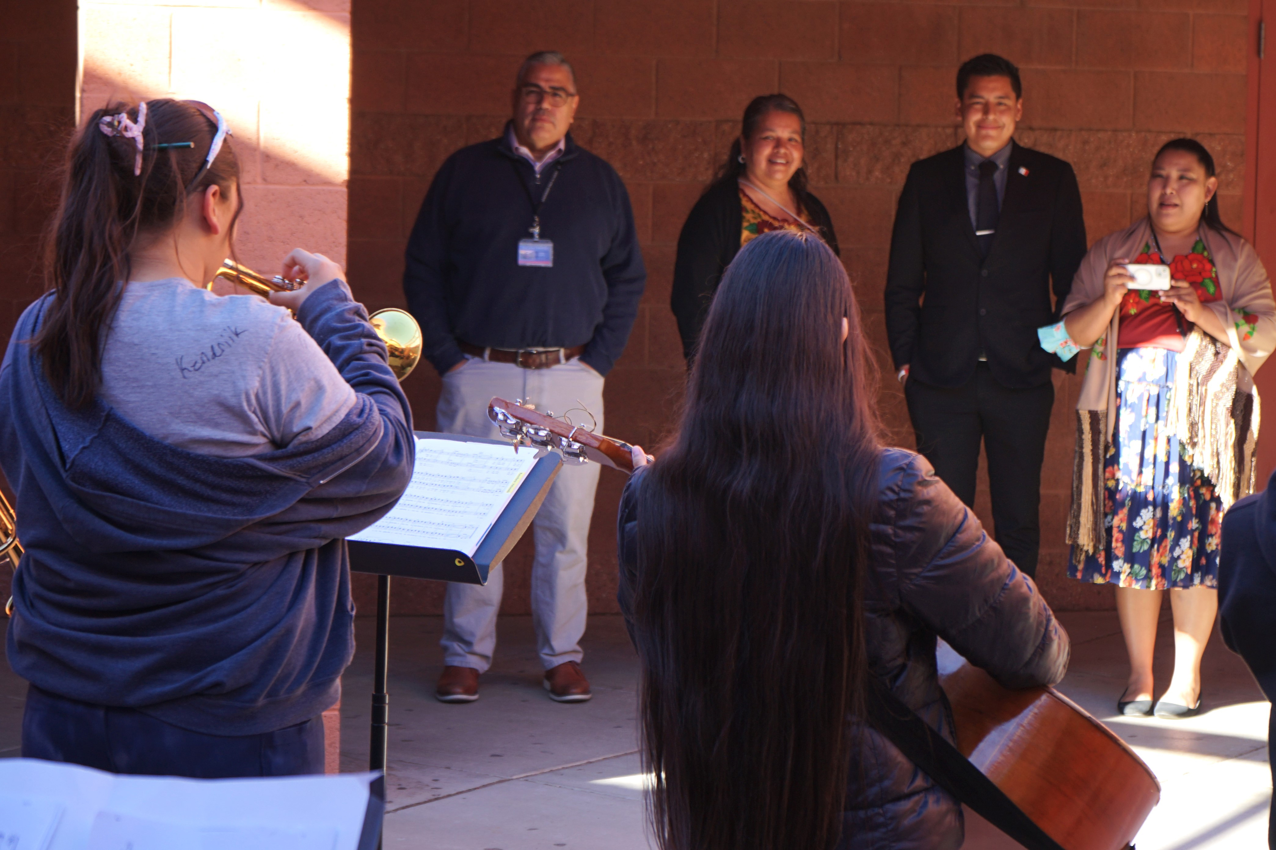 Staff watch student musicians perform