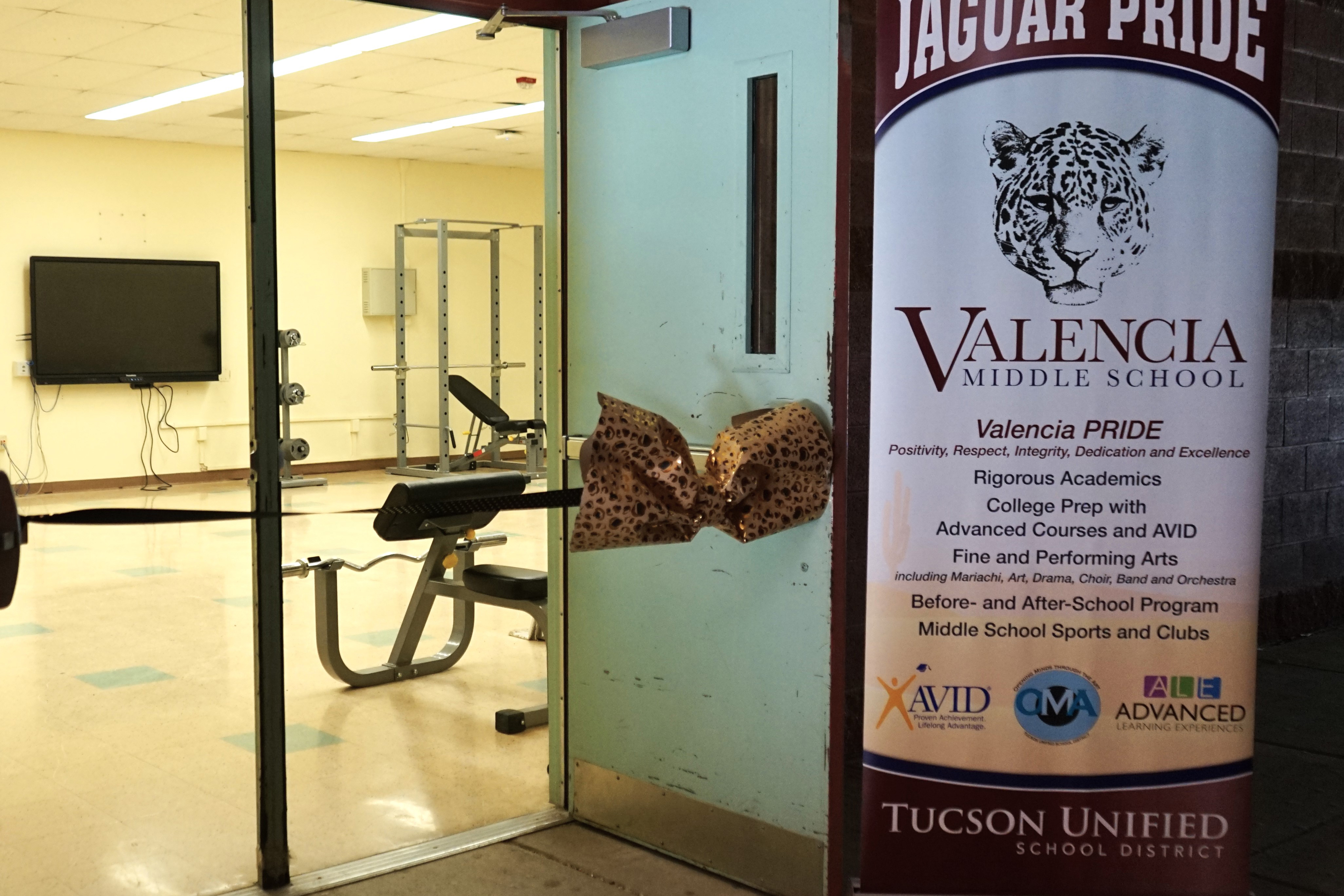 A peek into the new weight room with a Valencia banner outside